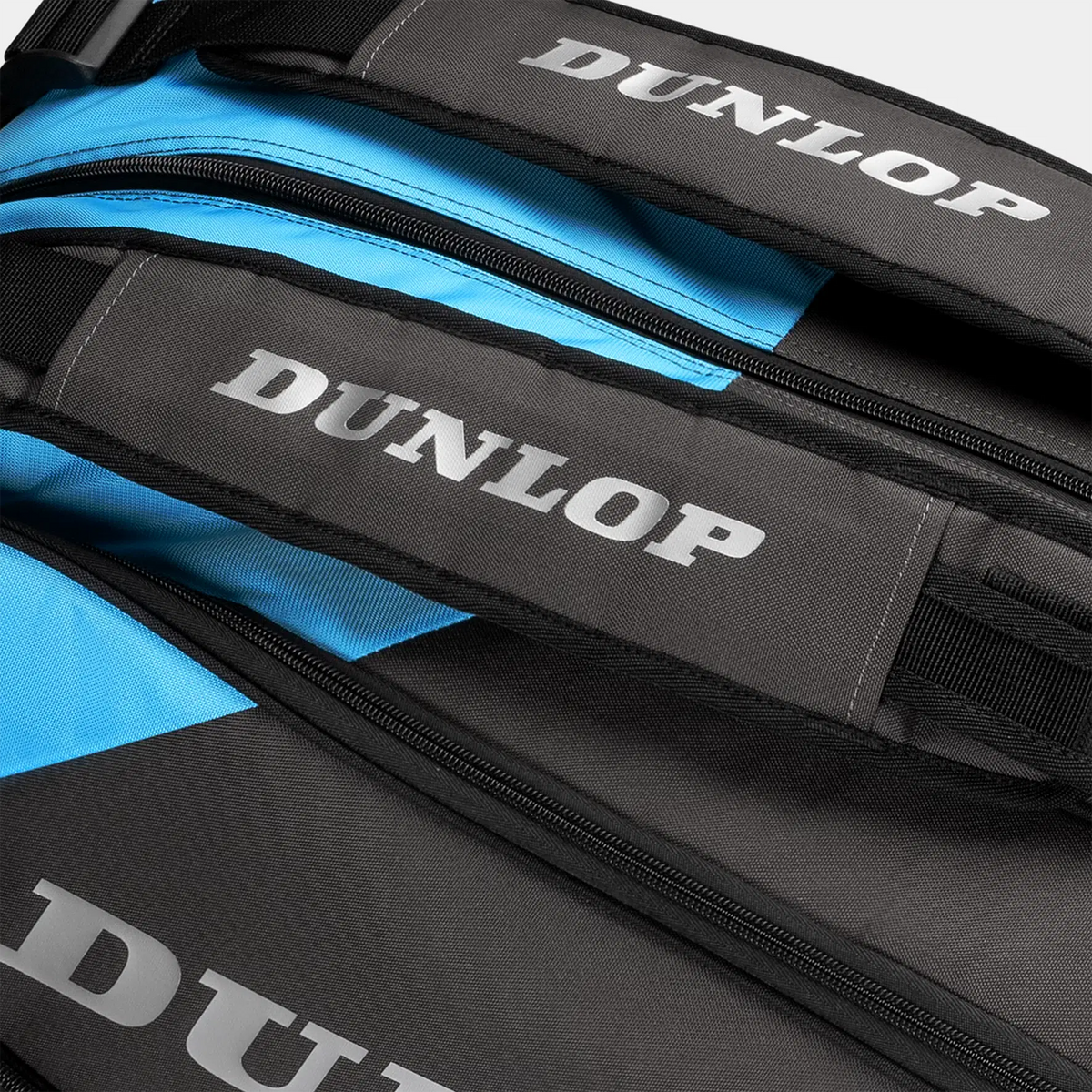 Close-up of a black and blue Dunlop tennis bag featuring silver brand lettering.